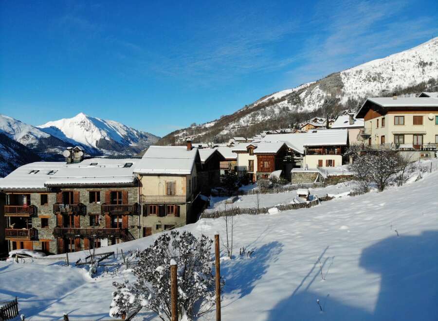 Discover a charming winter escape in this picturesque village nestled amidst snow-capped mountains.