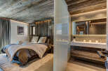 Experience rustic luxury in this stunning bedroom and bathroom.