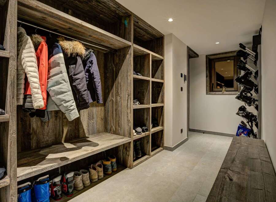 Step into a stylish ski chalet entryway, designed with rustic wooden features.