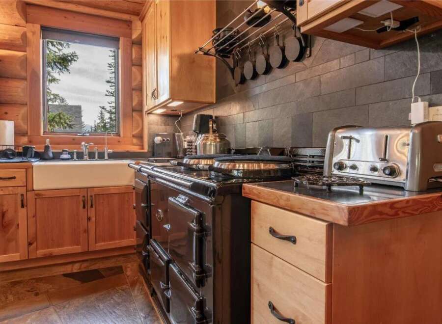 Step into a charming kitchen with rustic wooden cabinetry and a classic farmhouse sink.