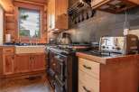Step into a charming kitchen with rustic wooden cabinetry and a classic farmhouse sink.