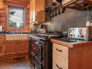 Step into a charming kitchen with rustic wooden cabinetry and a classic farmhouse sink.