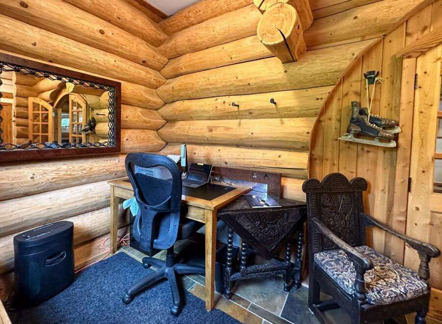 Step into rustic charm with this cozy log cabin home office.