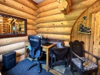 Step into rustic charm with this cozy log cabin home office.