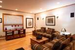 This cozy living room features a warm and inviting atmosphere with its wooden floors and comfortable seating.