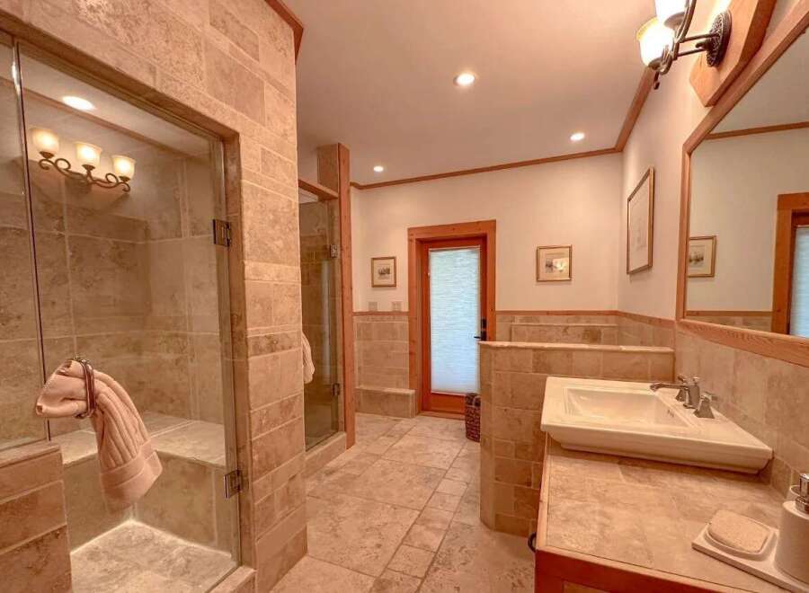 Step into luxury with this stunning bathroom! Featuring a spacious walk-in shower, elegant vanity, and beautiful tile work, this space is designed for relaxation.