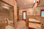 Step into luxury with this stunning bathroom! Featuring a spacious walk-in shower, elegant vanity, and beautiful tile work, this space is designed for relaxation.