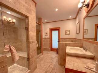 Step into luxury with this stunning bathroom! Featuring a spacious walk-in shower, elegant vanity, and beautiful tile work, this space is designed for relaxation.
