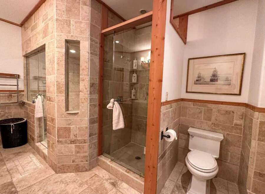 This luxurious bathroom features a stunning walk-in shower with glass doors and elegant tile work.