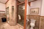 This luxurious bathroom features a stunning walk-in shower with glass doors and elegant tile work.