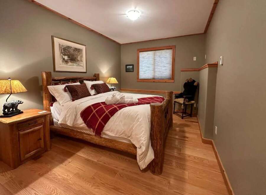 Cozy bedroom with rustic wooden furniture and a warm, inviting atmosphere.