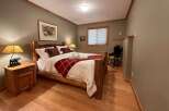 Cozy bedroom with rustic wooden furniture and a warm, inviting atmosphere.