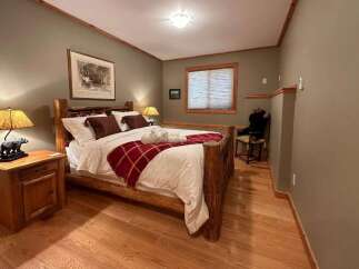 Cozy bedroom with rustic wooden furniture and a warm, inviting atmosphere.