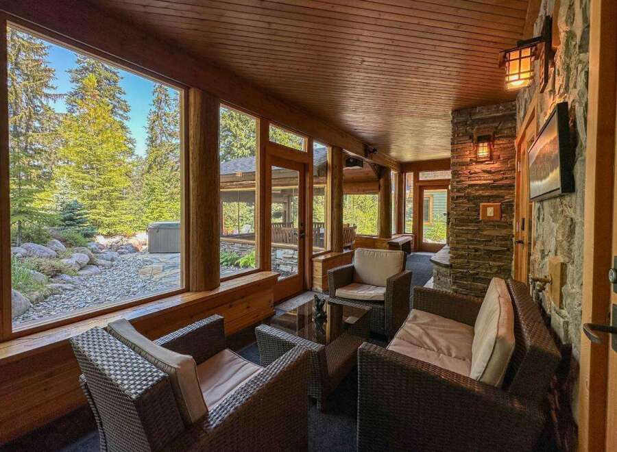 Experience the tranquility of this stunning property, featuring a sunroom with expansive windows that frame breathtaking views of the surrounding nature.
