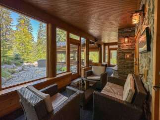 Experience the tranquility of this stunning property, featuring a sunroom with expansive windows that frame breathtaking views of the surrounding nature.