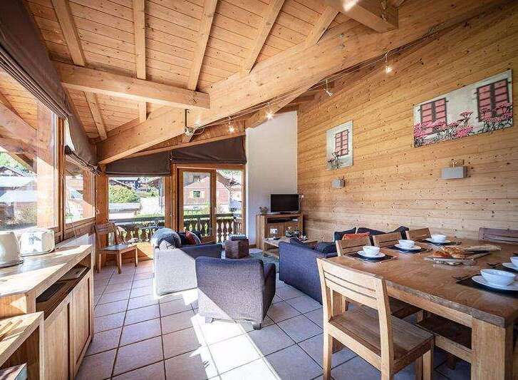 Experience the charm of this cozy chalet, featuring a warm wooden interior and a bright, airy atmosphere.