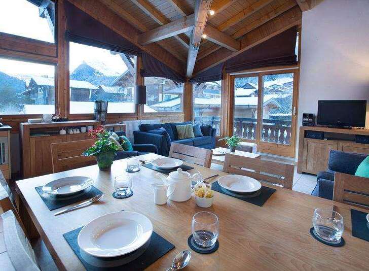 Experience the charm of this cozy chalet, featuring a dining area with stunning mountain views.