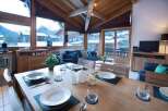 Experience the charm of this cozy chalet, featuring a dining area with stunning mountain views.