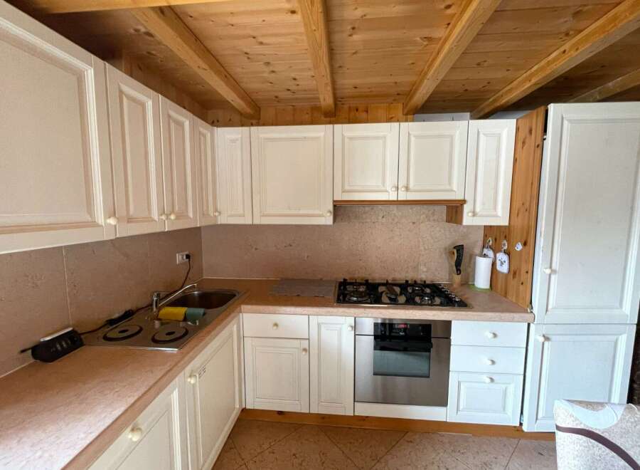 This charming kitchen features classic white cabinetry, offering ample storage and a bright, airy feel.