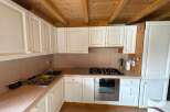 This charming kitchen features classic white cabinetry, offering ample storage and a bright, airy feel.