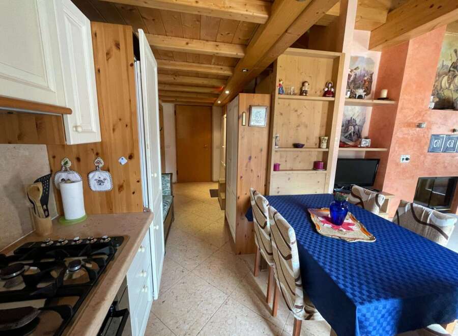 Cozy kitchen with wooden accents and a charming dining area.