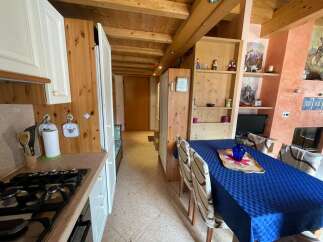 Cozy kitchen with wooden accents and a charming dining area.