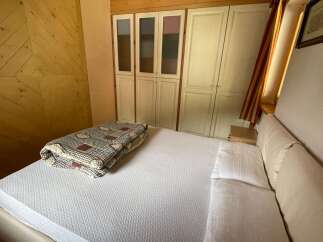 Discover a cozy bedroom with a comfortable bed and a stylish quilt.