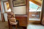 Discover a charming retreat with this cozy desk area, perfect for work or relaxation.