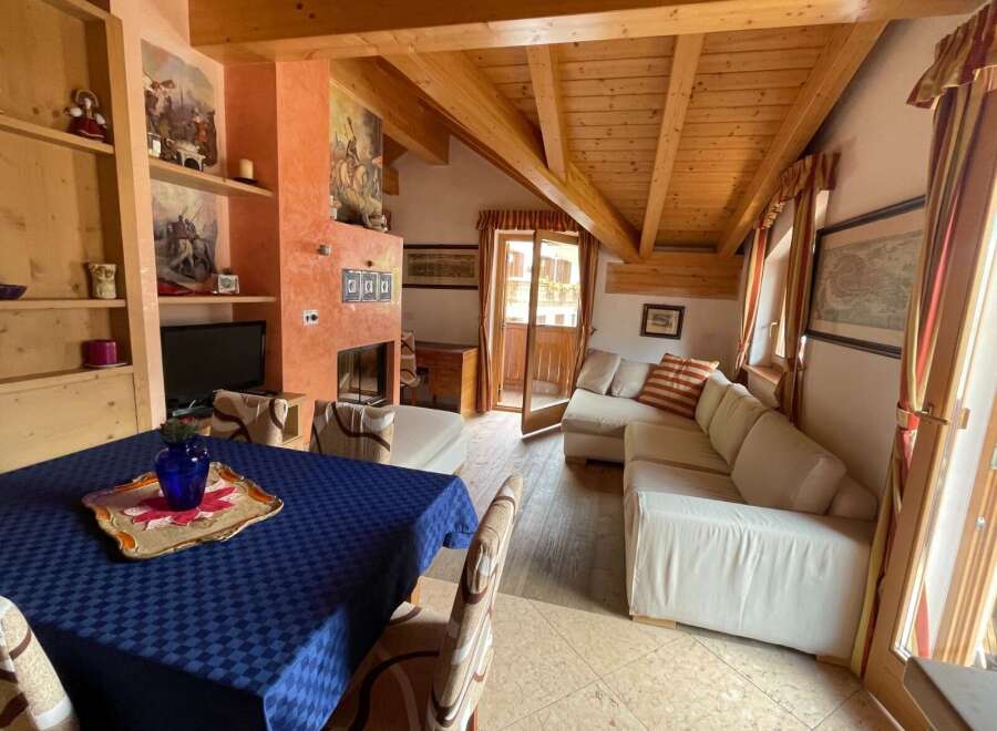 Charming living area featuring a wooden ceiling with exposed beams, adding warmth and character.