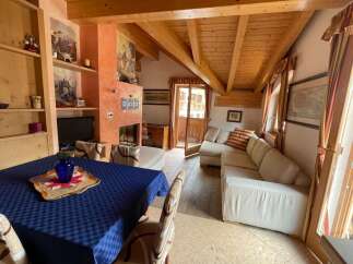 Charming living area featuring a wooden ceiling with exposed beams, adding warmth and character.