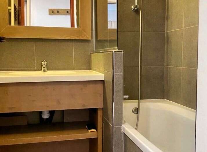Discover a stylish bathroom featuring a sleek vanity with ample storage and a modern design.