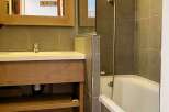 Discover a stylish bathroom featuring a sleek vanity with ample storage and a modern design.
