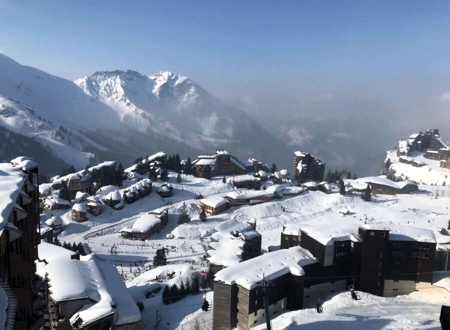 Experience the ultimate winter getaway in this stunning snow-covered village nestled in the mountains.