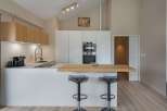 Modern kitchen design with sleek white cabinetry and a stylish breakfast bar.