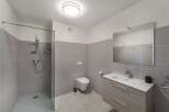 Step into this modern bathroom, featuring a sleek shower enclosure and contemporary fixtures.