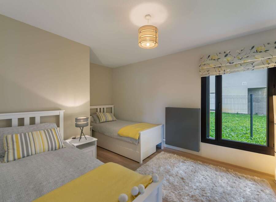 Discover a cozy bedroom with two twin beds, perfect for guests or a shared space.