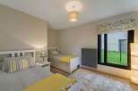 Discover a cozy bedroom with two twin beds, perfect for guests or a shared space.