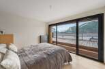 Experience breathtaking mountain views from this luxurious bedroom.