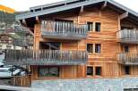Discover the charm of this stunning wooden chalet, boasting a beautiful stone base and multiple balconies.