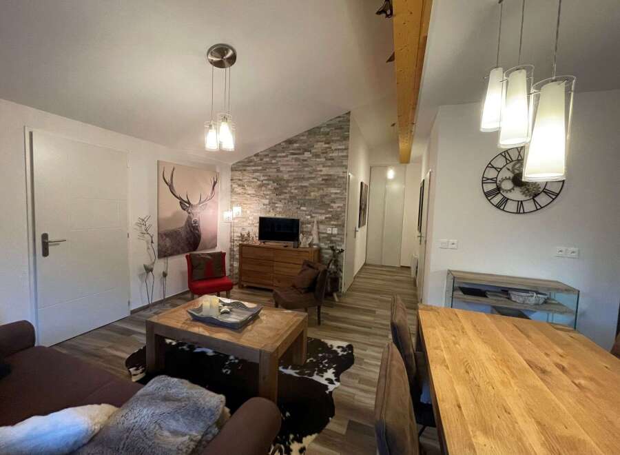 This cozy living space features a stylish blend of rustic and modern elements.