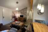 This cozy living space features a stylish blend of rustic and modern elements.