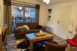 Cozy living room with a comfortable brown sofa and a stylish coffee table.