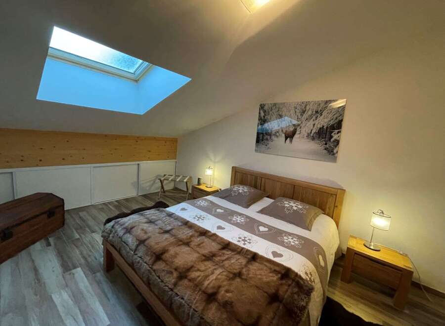 Cozy bedroom with a skylight, perfect for a relaxing getaway.