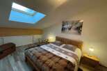 Cozy bedroom with a skylight, perfect for a relaxing getaway.