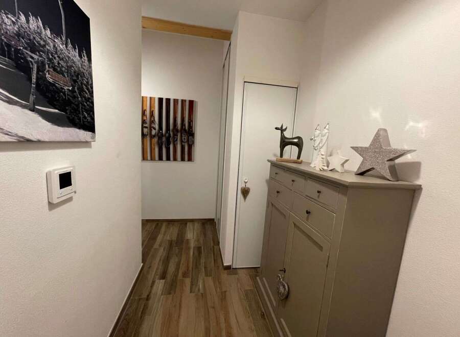 This inviting hallway showcases a blend of modern and rustic design elements.