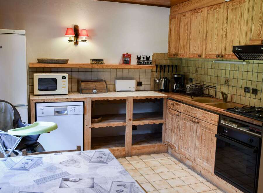 This charming kitchen features rustic wooden cabinetry and a cozy atmosphere.