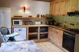 This charming kitchen features rustic wooden cabinetry and a cozy atmosphere.