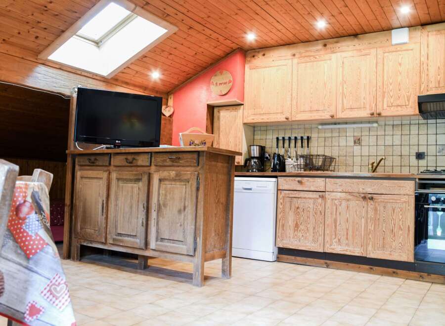 This charming kitchen boasts a rustic, wooden design, creating a warm and inviting atmosphere.