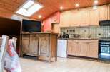 This charming kitchen boasts a rustic, wooden design, creating a warm and inviting atmosphere.