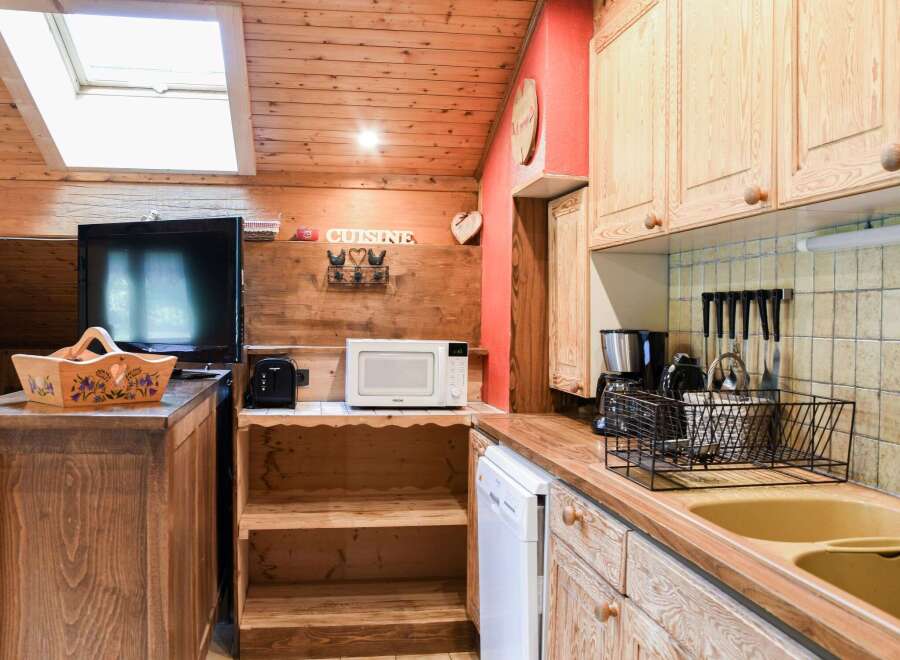 Cozy kitchen with wooden cabinets and a charming rustic design.